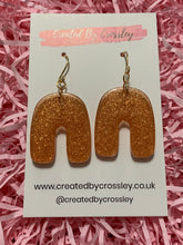 Load image into Gallery viewer, Bronze Shimmer Arch Resin Earrings
