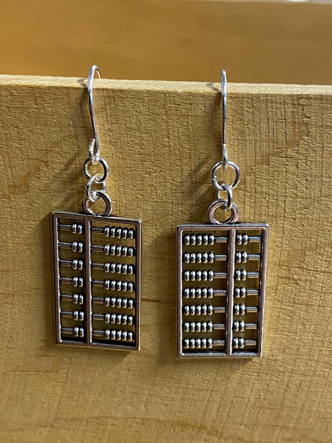 earrings with silver coloured findings and rectangle abacus charms.