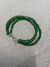 Load image into Gallery viewer, image shows a bracelet against a white background. The bracelet has three strands of green beads all attached together with a silver lobster clasp and chain
