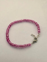 Load image into Gallery viewer, image shows a bracelet against light grey background. bracelet had a single band of shiny pink beads and a silver lobster clasp and extender chain
